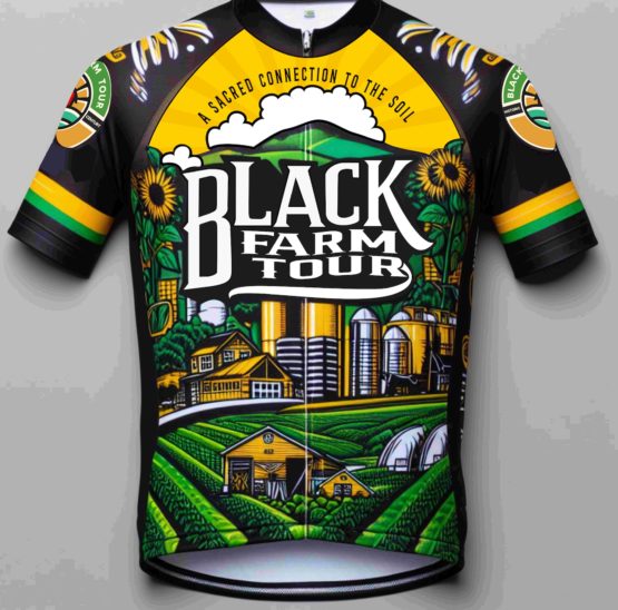 image of black farm tour jersey. black base color with a field of crops in green with yellow buildings in the midst of the field and yellow silos in the background. The words Black Farm Tour are stylized on the chest and flanked by large sunflowers.